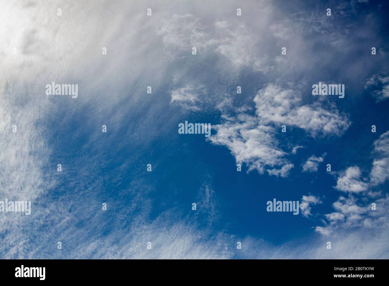 wispy clouds seen through lower level layer Stock Photo