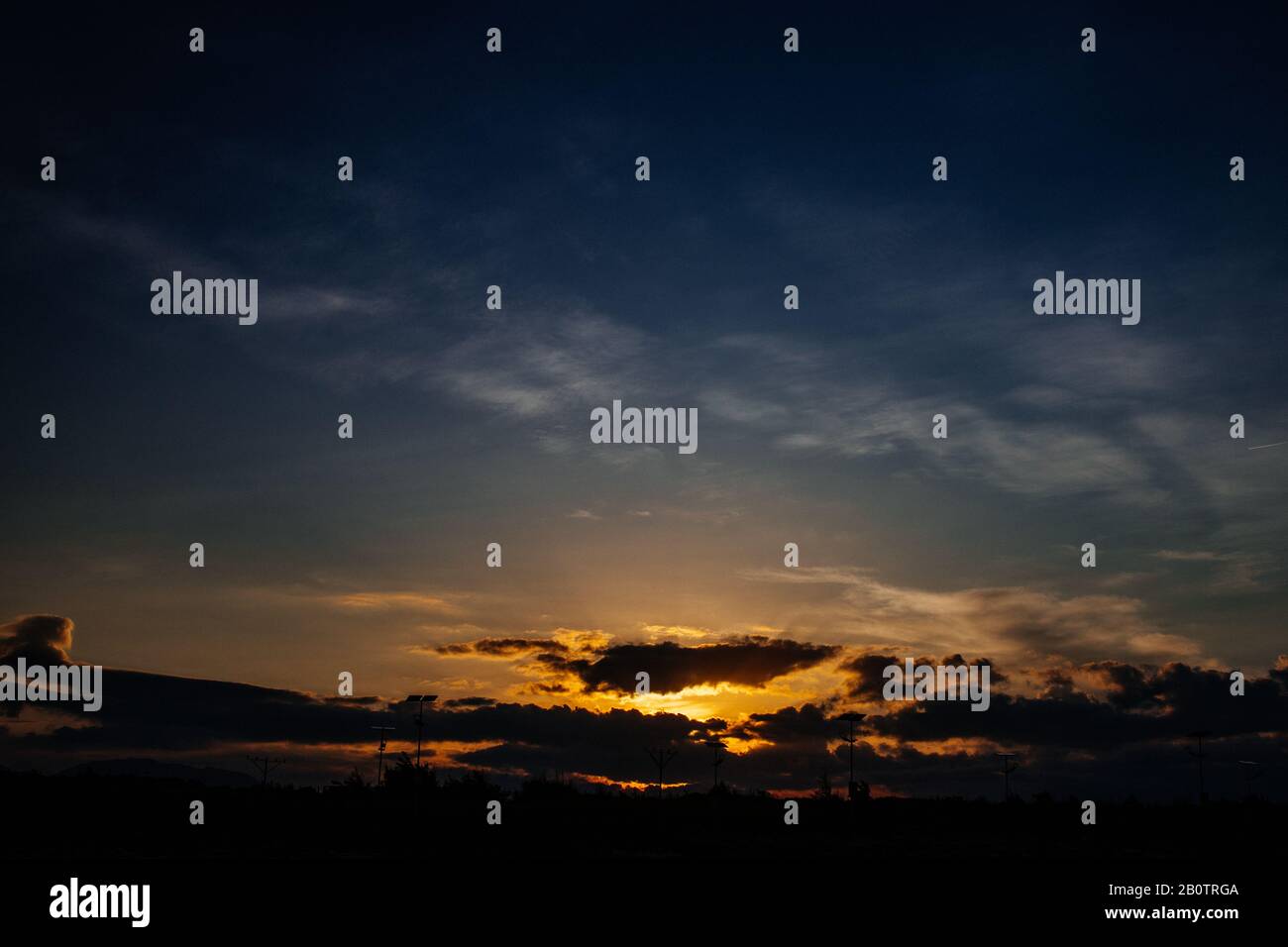 Dramatic sunset sky. Bright colors of sun going down. Sunlight rays