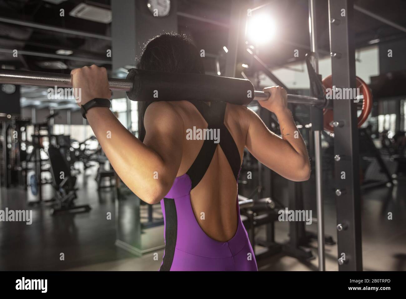 Strong. Young muscular caucasian woman practicing in gym with equipment