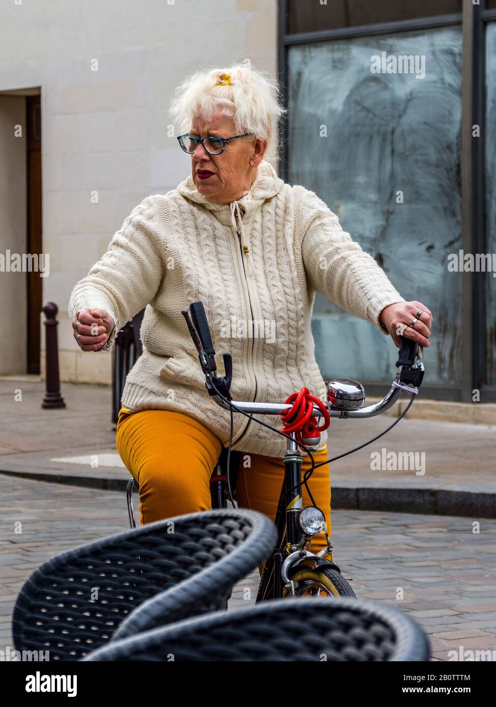 Middle aged woman on bicycle. Stock Photo