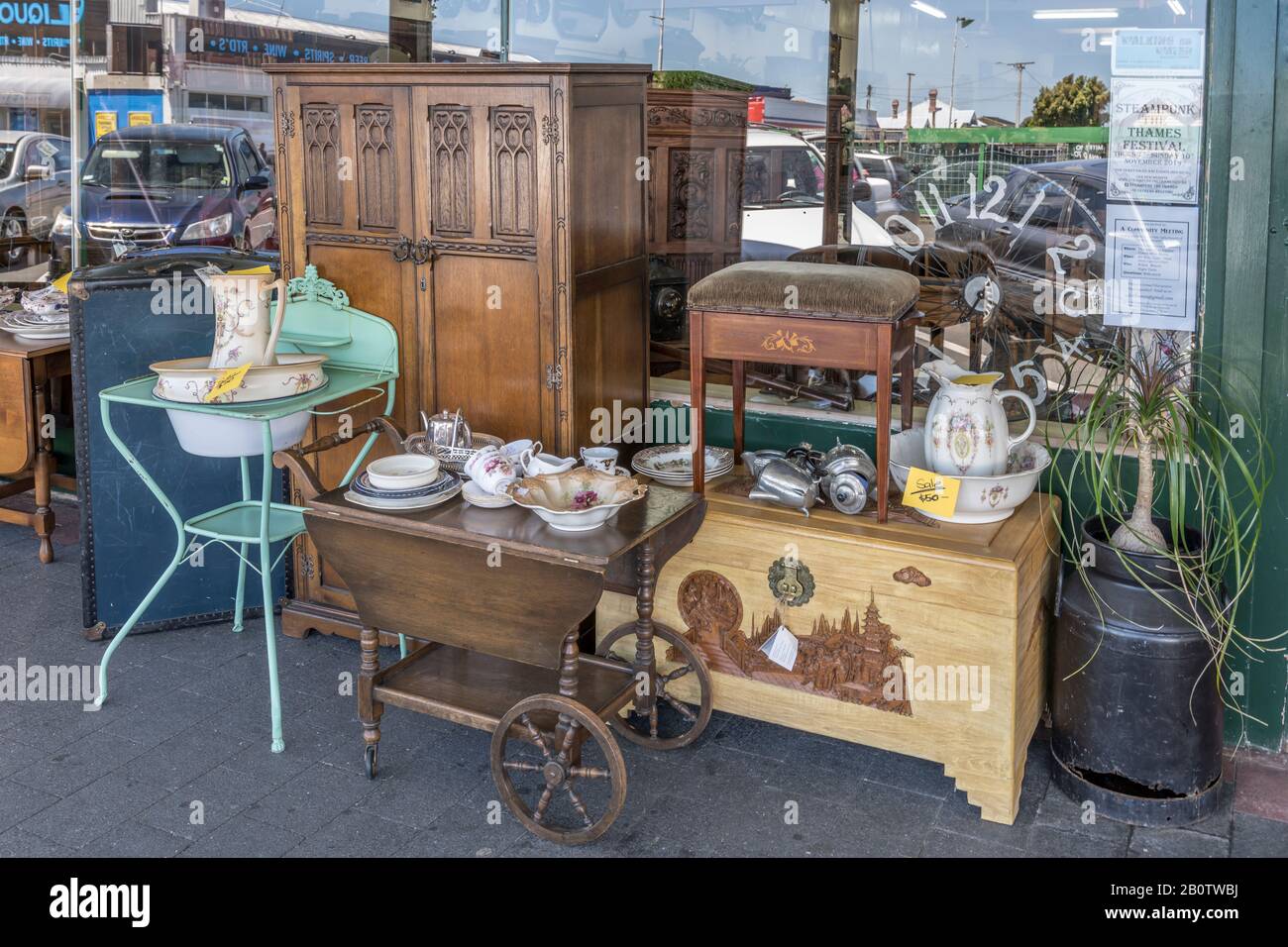 THAMES, NEW ZEALAND - November 07 2019: cityscape of historical village with old furniture on sale under commercial buildings covered walkway on main Stock Photo