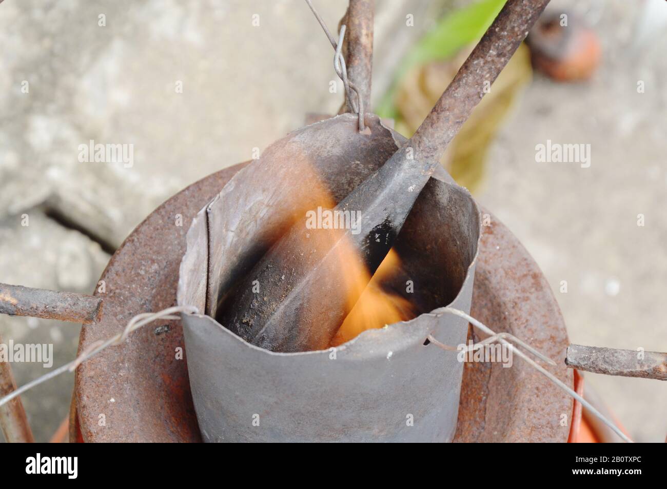 soldering iron burn in tin bucket for steel welding work Stock Photo