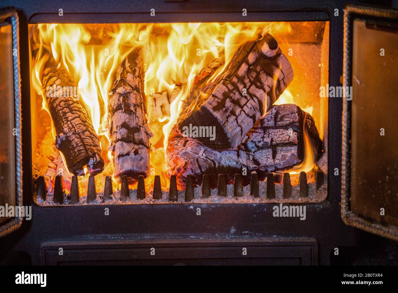 Piicture shows wood on fire in a wood burning stove. Owners of wood burners, stoves and open