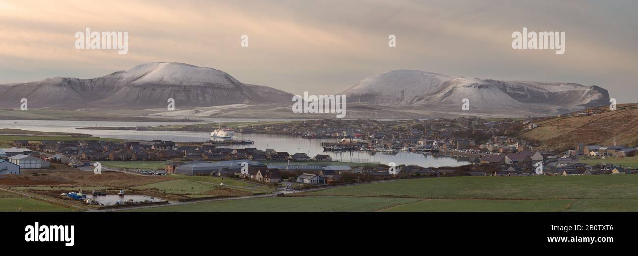 Northlink ferry approaching Stromness with snow covered Hoy beyond, Orkney Isles Stock Photo