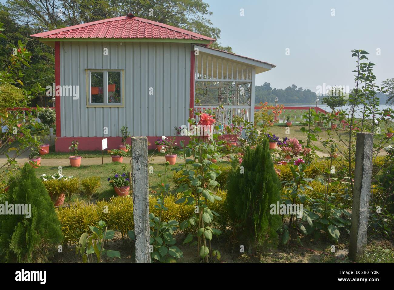 Close up of a small prefabricated house with tiled roof made of synthetic material and white wall of prefiber material with beautiful garden Stock Photo