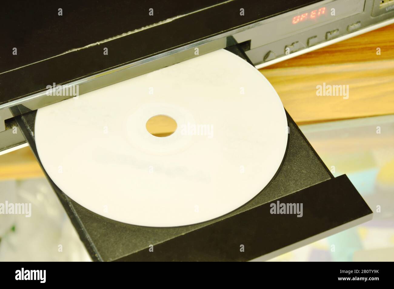 DVD put on insert disc player in wooden cupboard Stock Photo