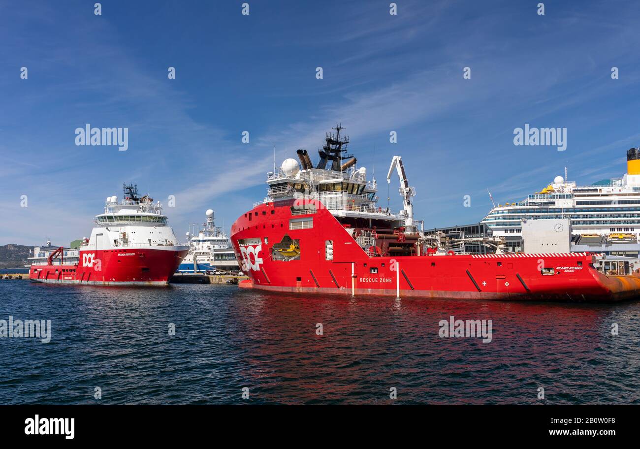 BERGEN, NORWAY - Commercial ships Scandi Bergen, left, and Scandi Iceman, deepsea anchor handling vessels, docked in harbour. Stock Photo