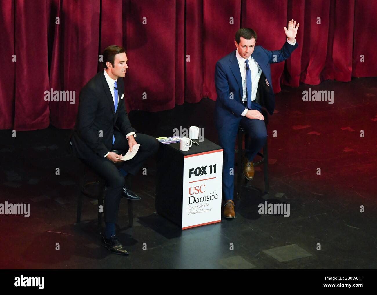 Democratic presidential candidate Pete Buttigieg (r) attends Fox11 Town Hall hosted by Elex Michaelson (l) to speak at a USC Political Assembly at Bovard Auditorium at USC on February 21, 2020 in Los Angeles, California.. Stock Photo