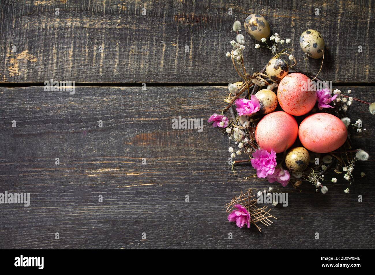 Easter background with Pink handmade Easter eggs and spring flowers. Top view flat lay background. Copy space. Stock Photo