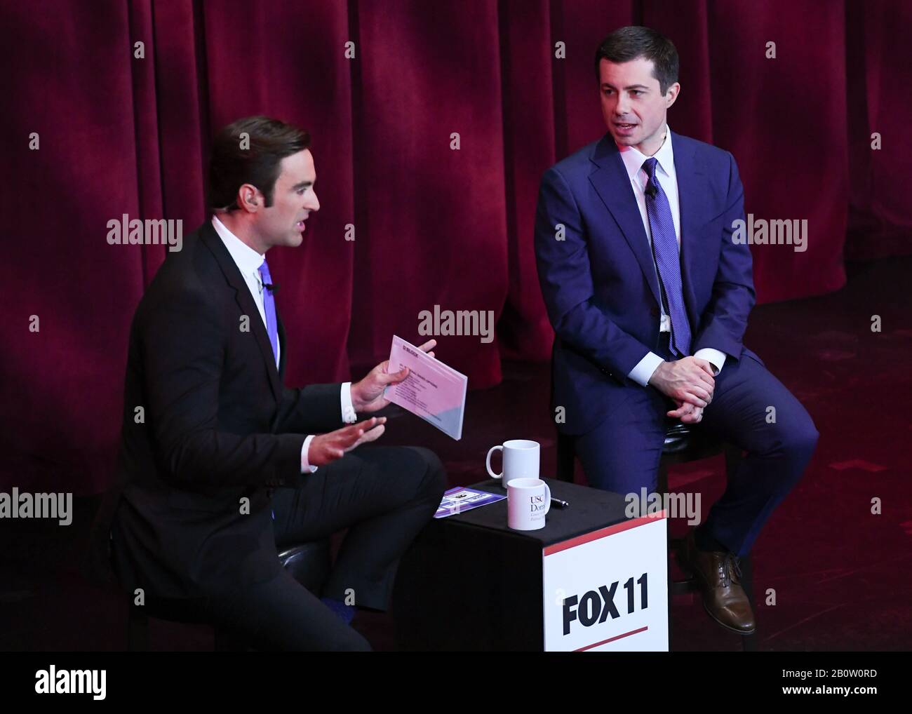 Democratic presidential candidate Pete Buttigieg (r) attends Fox11 Town Hall hosted by Elex Michaelson (l) to speak at a USC Political Assembly at Bovard Auditorium at USC on February 21, 2020 in Los Angeles, California.. Stock Photo