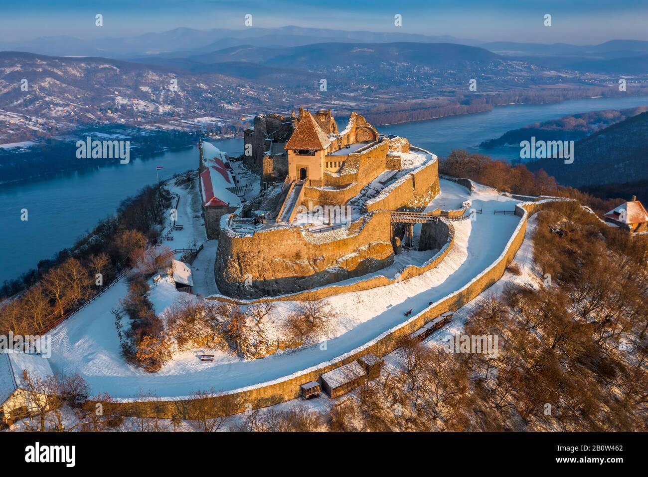 Visegrad, Hungary - Aerial view of the beautiful snowy high castle of Visegrad at sunrise with Dunakanyar at background on a winter morning Stock Photo