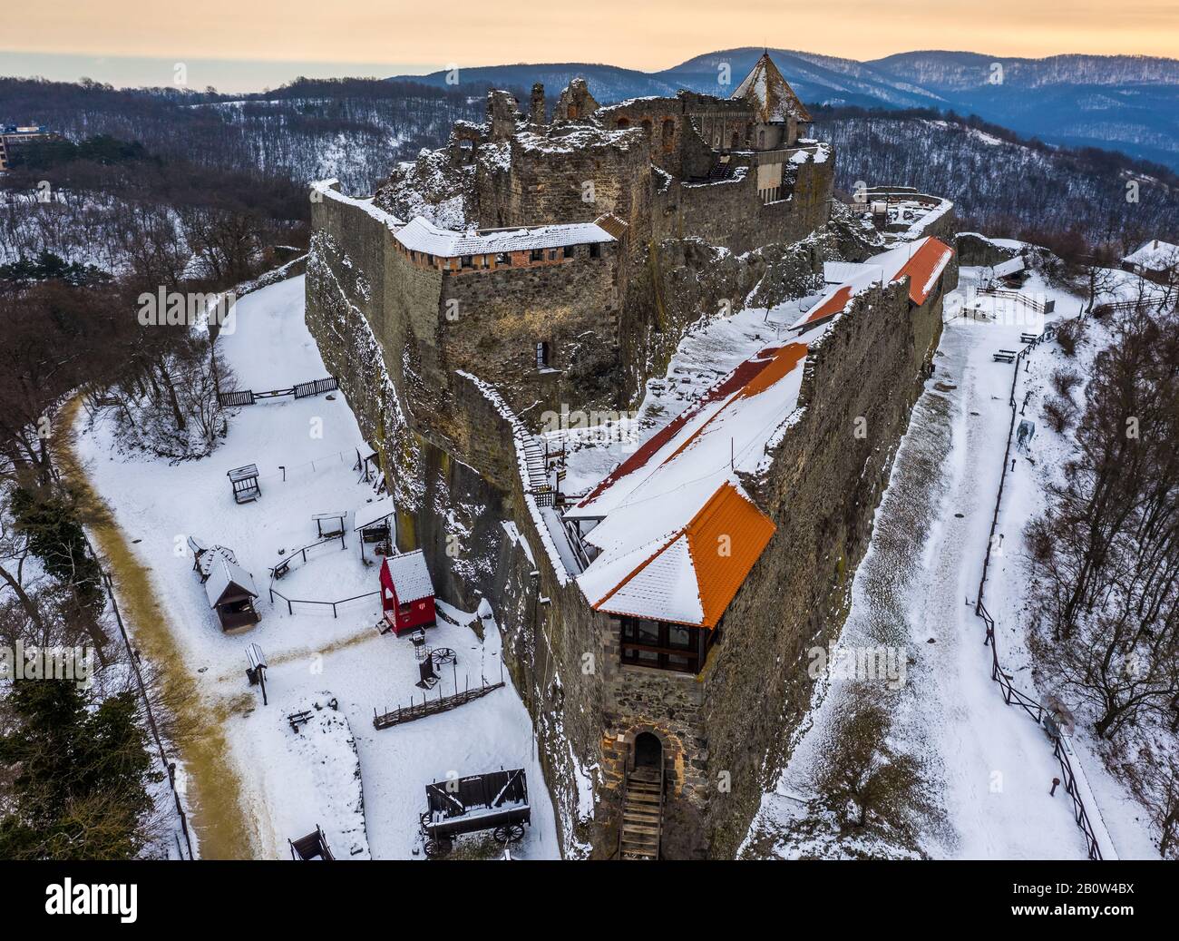 Visegrad, Hungary - Aerial view of the beautiful snowy high castle of Visegrad at sunrise on a winter morning with the hills of Pilis at background Stock Photo