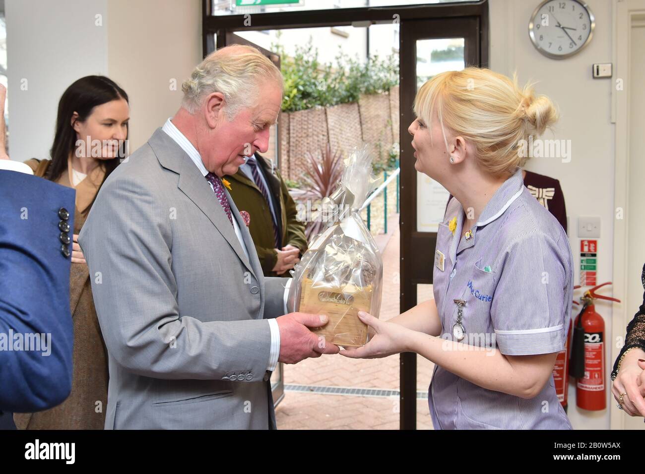The Prince of Wales receives a gift from Healthcare Assistant Kathryn Guercio during a visit to the Marie Curie Hospice in Cardiff and the Vale, Wales. Stock Photo