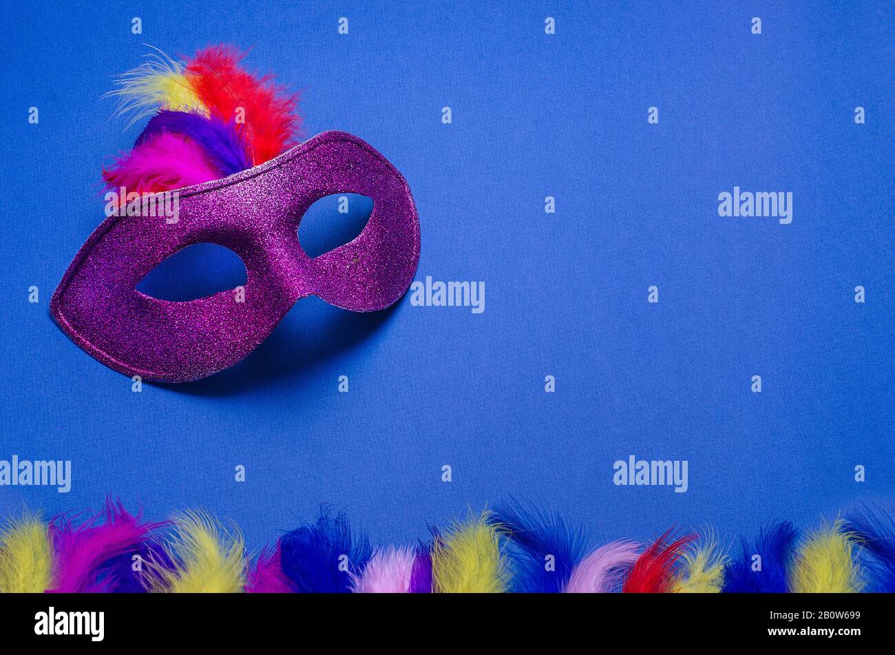 Carnival. Festive background with copy space. Violet carnival mask with