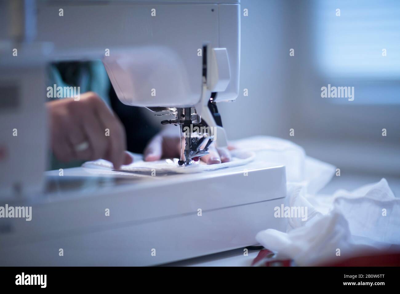 Close up of female tailor using sewing machine Stock Photo - Alamy