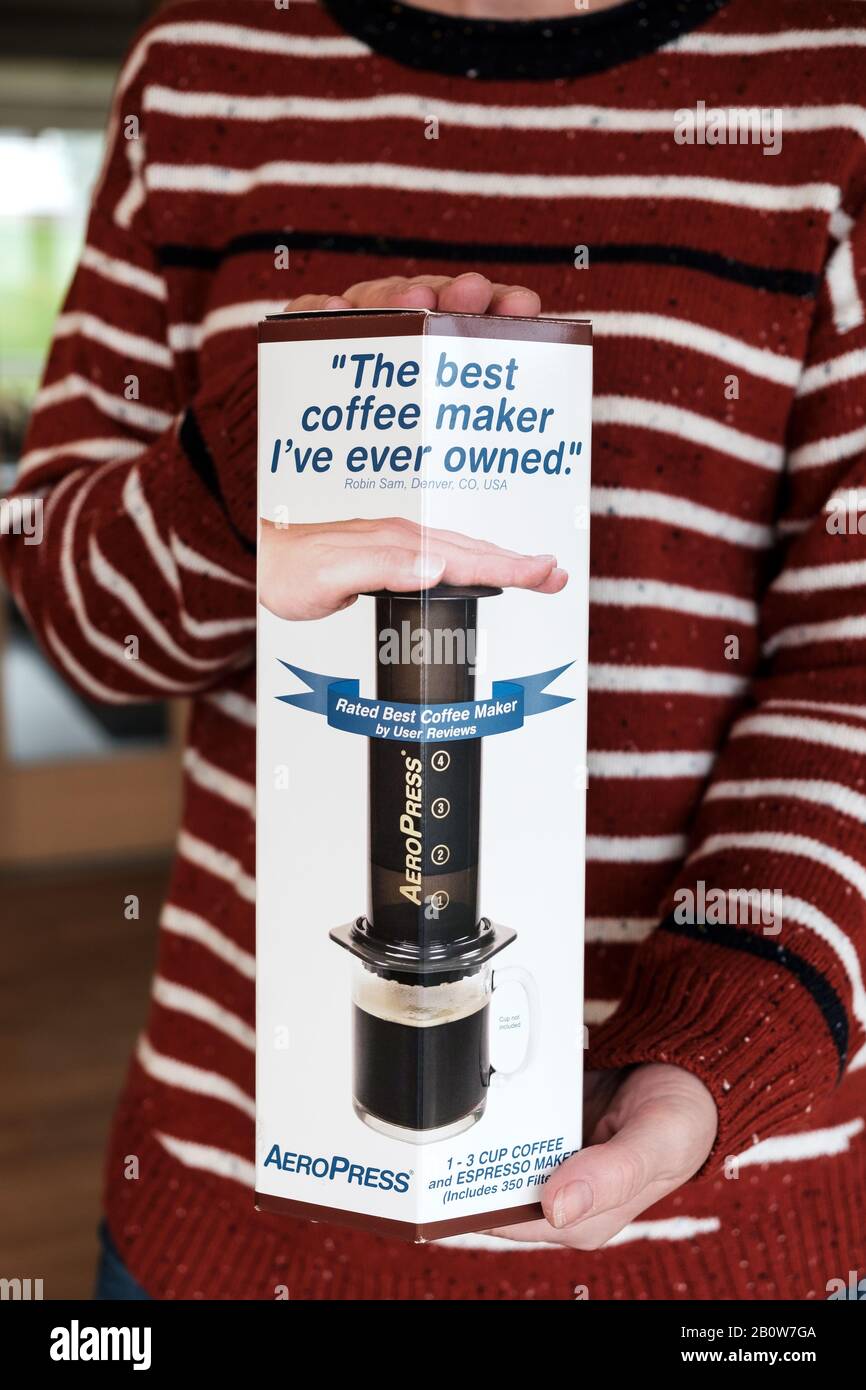A new, boxed Aeropress coffee maker being held by a middle aged female  showing off her new purchase Stock Photo - Alamy