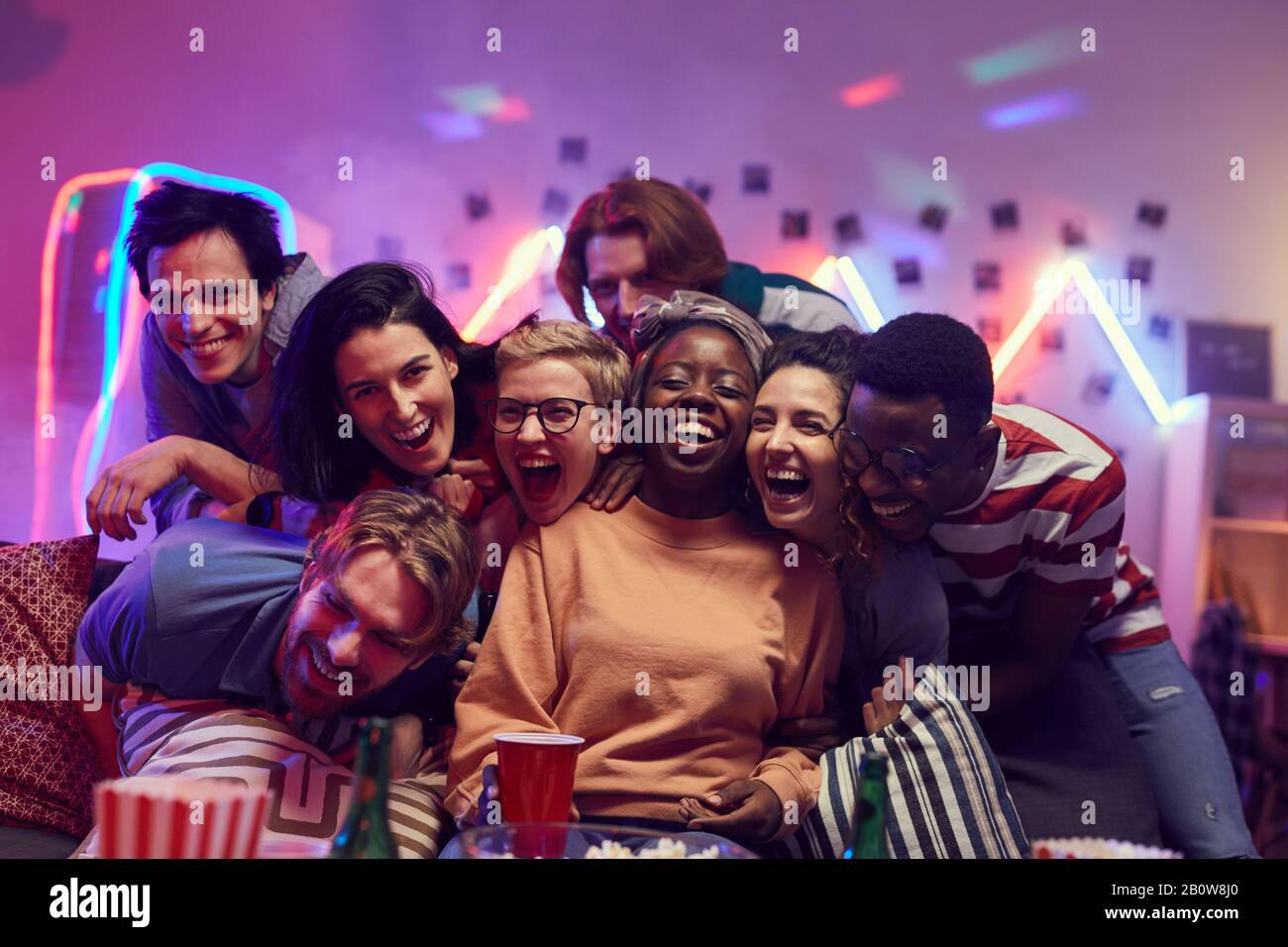 Portrait of multiethnic group of young people laughing and having fun together at the party Stock Photo
