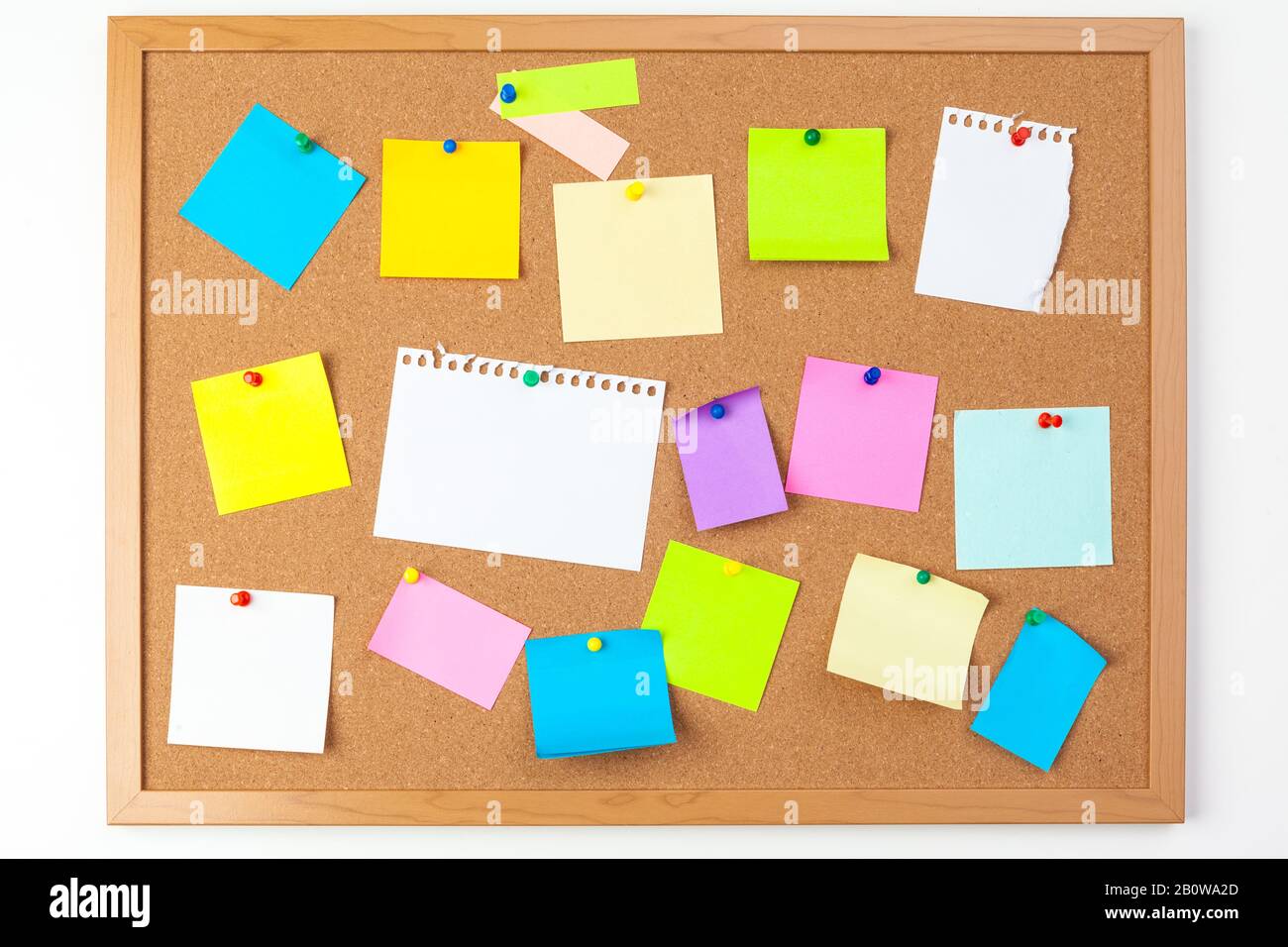 Cork board with several colorful blank notes with pins Stock Photo
