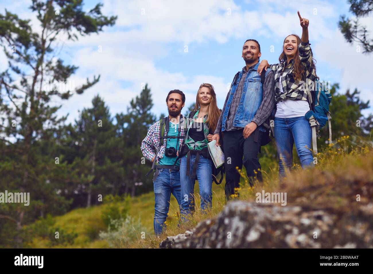 A group of hikers with backpacks are standing in the forest Stock Photo ...