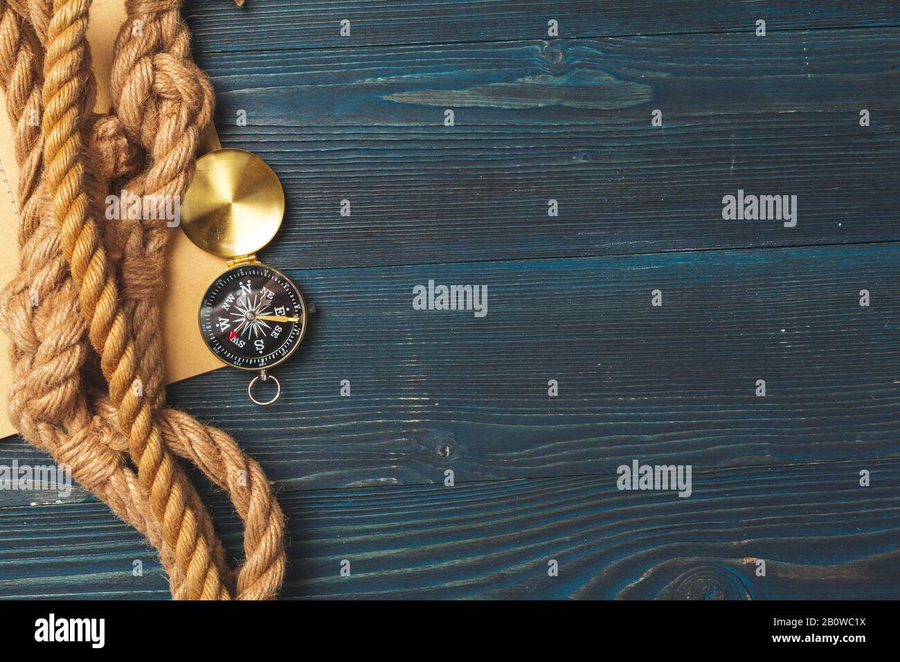 Nautical background. Sailing rope with a compass Stock Photo - Alamy