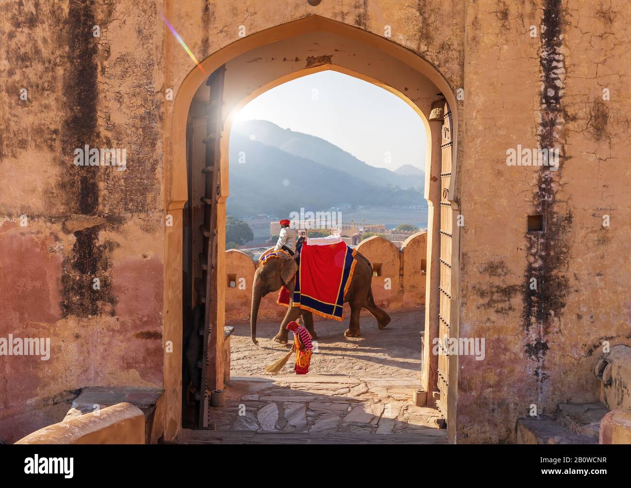 Indian man on the elephant and indian woman working in Amber Fort, Jaipur, India Stock Photo