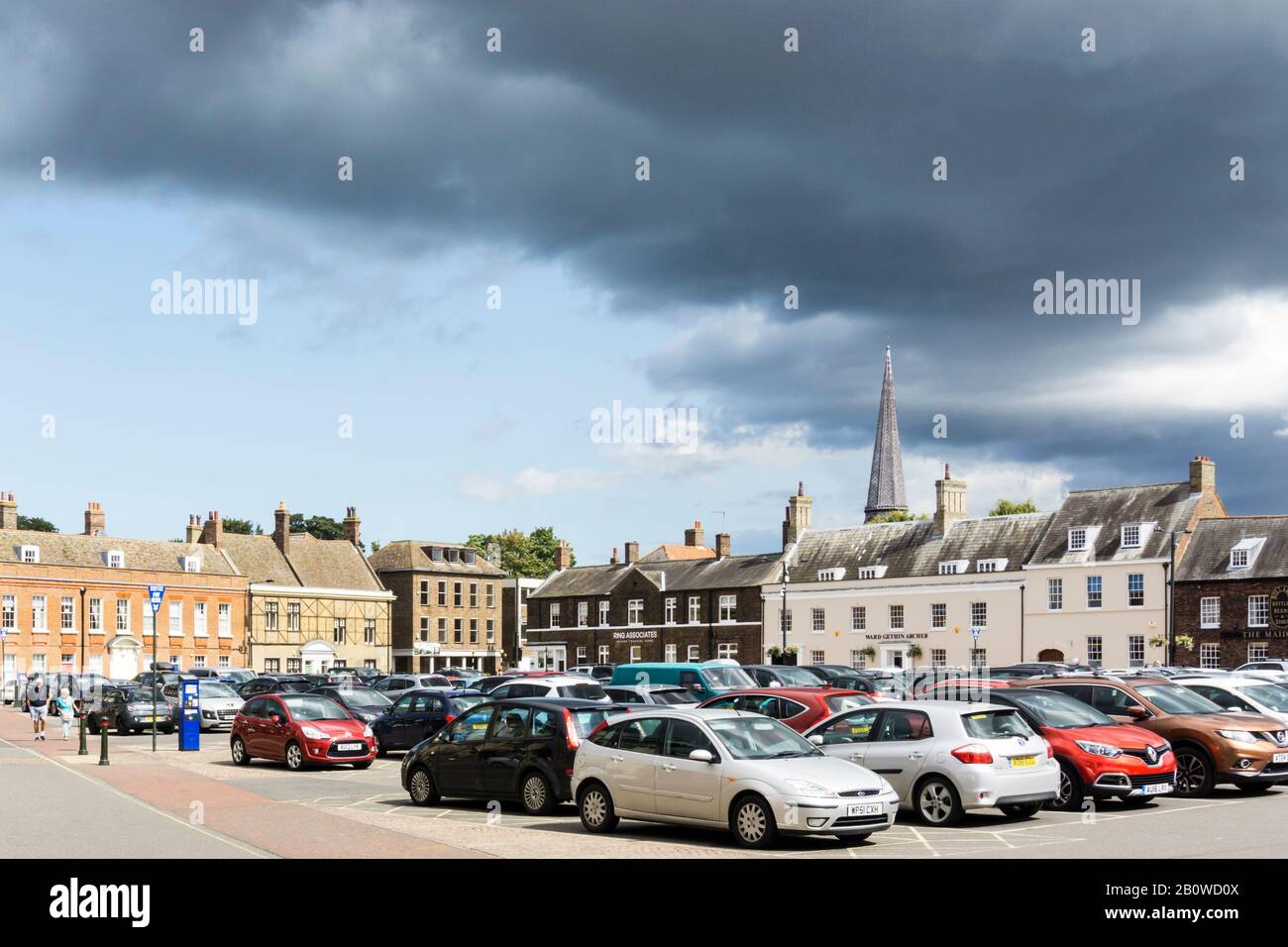 Cars parked on the Tuesday Market Place in the historic centre of King's Lynn, Norfolk. Stock Photo