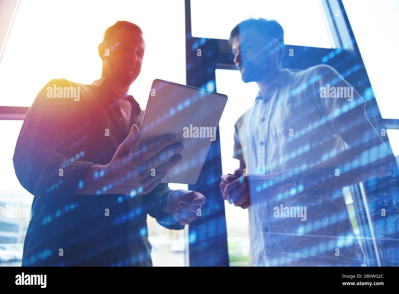 Background concept with business people silhouette looking at the tablet. Double exposure and light effects Stock Photo