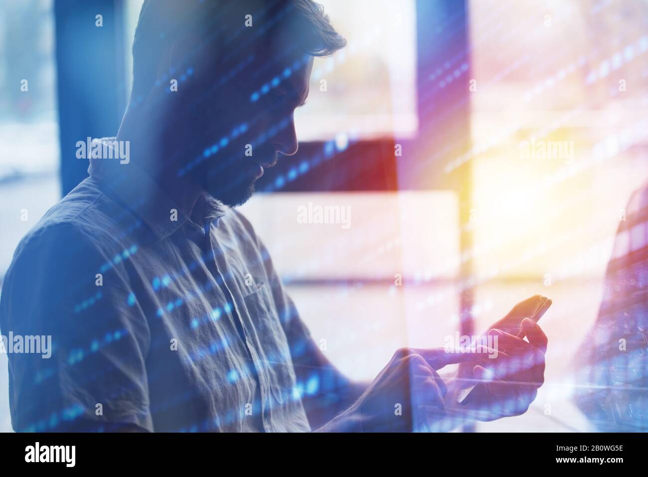 Young man using a mobile phone connected to internet. Double exposure and light effect Stock Photo