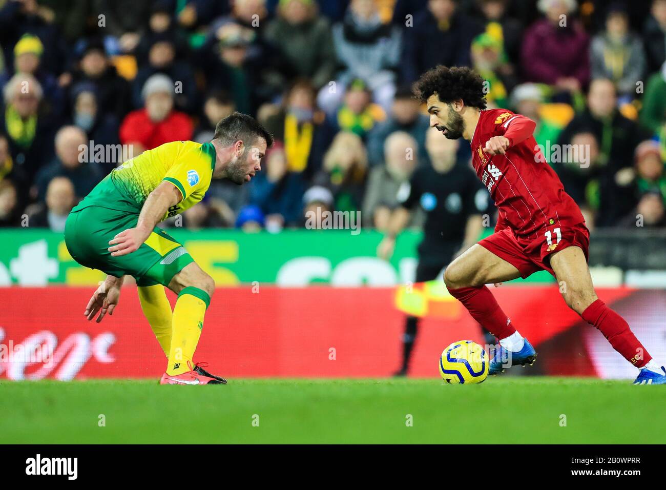 15th February 2020, Carrow Road, Norwich, England; Premier League, Norwich City v Liverpool : Mohamed Salah (11) of Liverpool tries to find a way passed Grant Hanley (05) of Norwich City Stock Photo