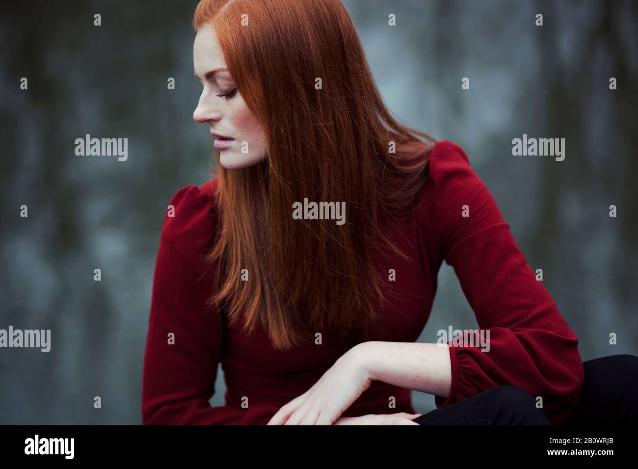 Woman with long red hair, portrait Stock Photo - Alamy