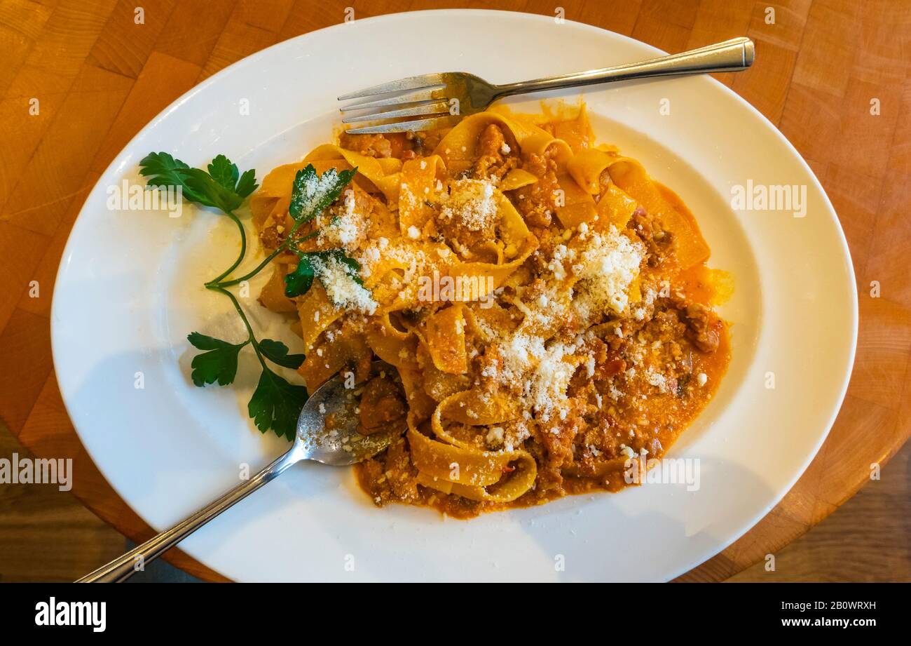 A bowl of pappardelle pasta with a rustic meat sauce with parmesan cheese Stock Photo Alamy