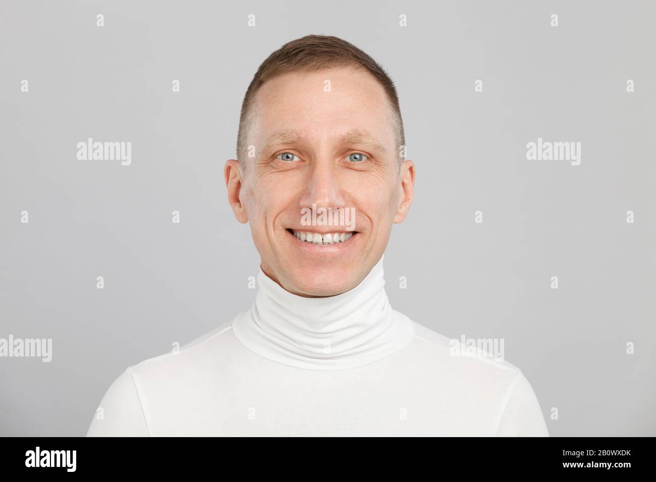 middle-aged man headshot in a white turtleneck. Stock Photo