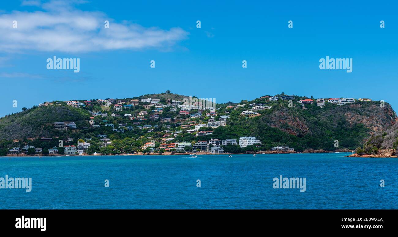 Knysna Lagoon, Mossel Bay, South Africa -- January 9, 2018. Photo overlooking the lagoon to houses built on the side of a hill in Mossel Bay. Stock Photo