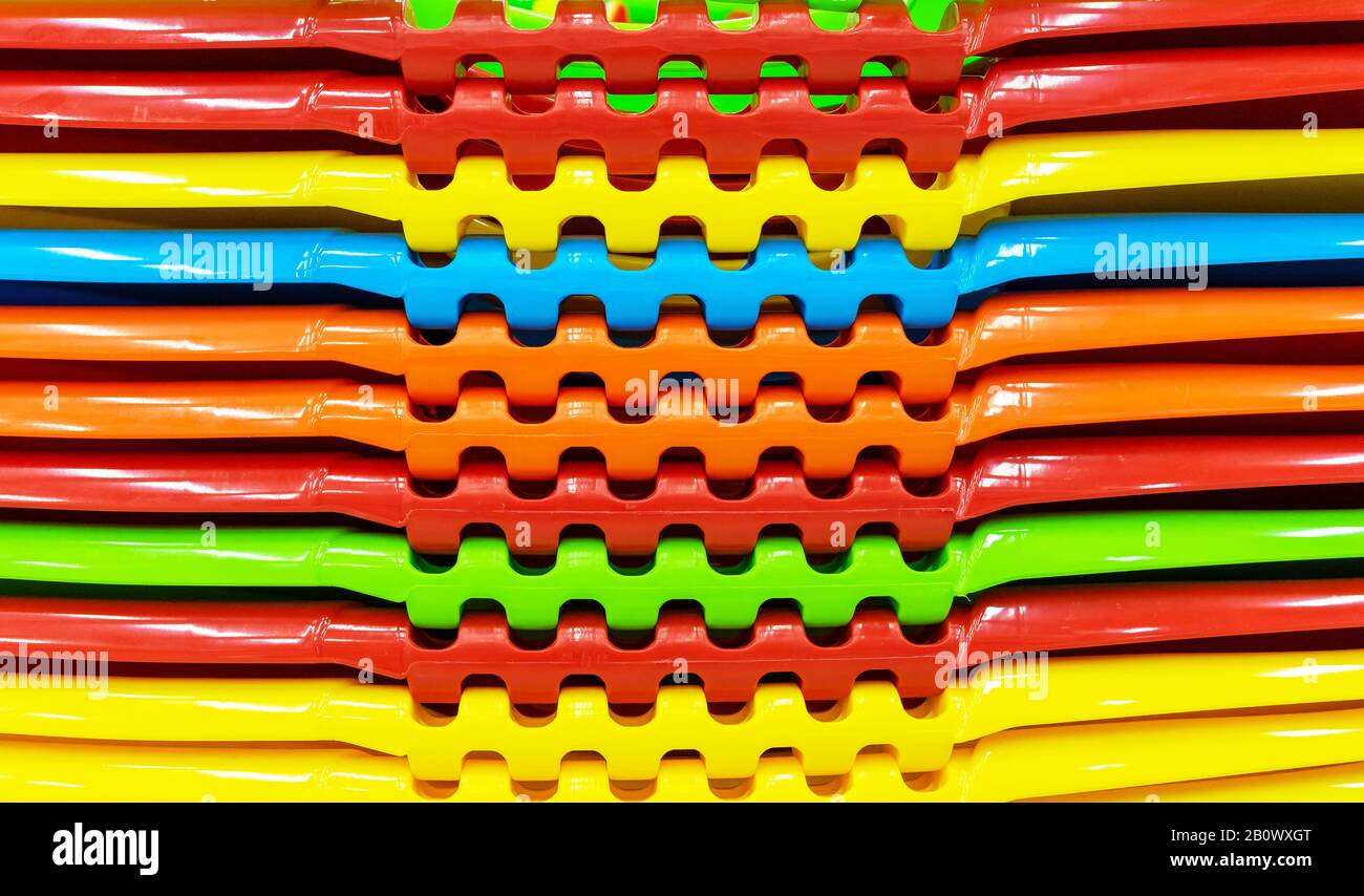 Multi-colored plastic containers stacked in a stack. Stock Photo