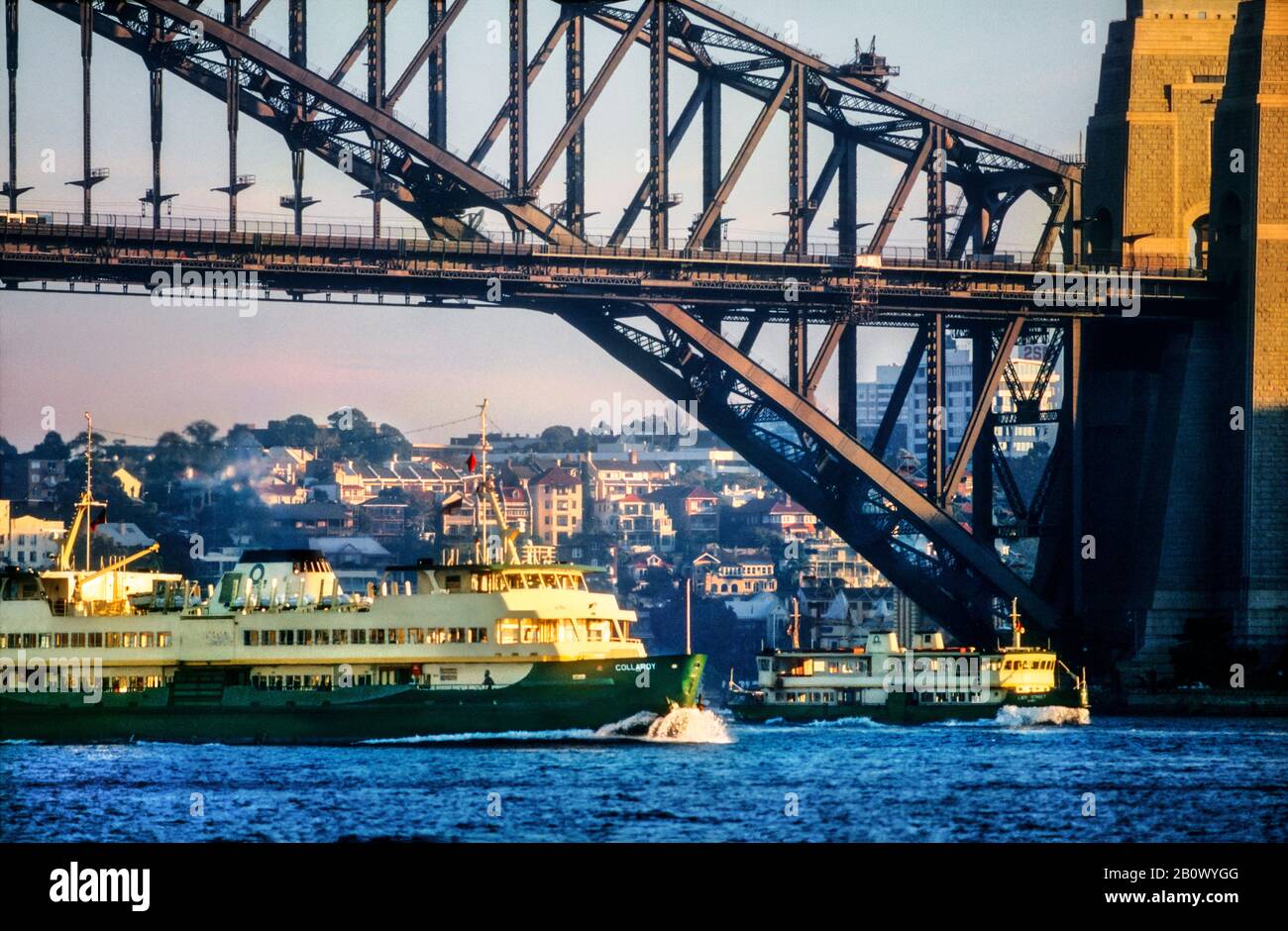 Ferries crossing under Sydney Harbour Bridge, Circular Quay, Sydney, New South Wales, Australia Stock Photo