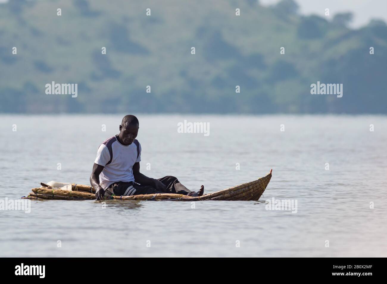 A local Chamus or Njemps Kenyan fisherman in traditional reed fishing boat on lake Baringo, Kenya Stock Photo