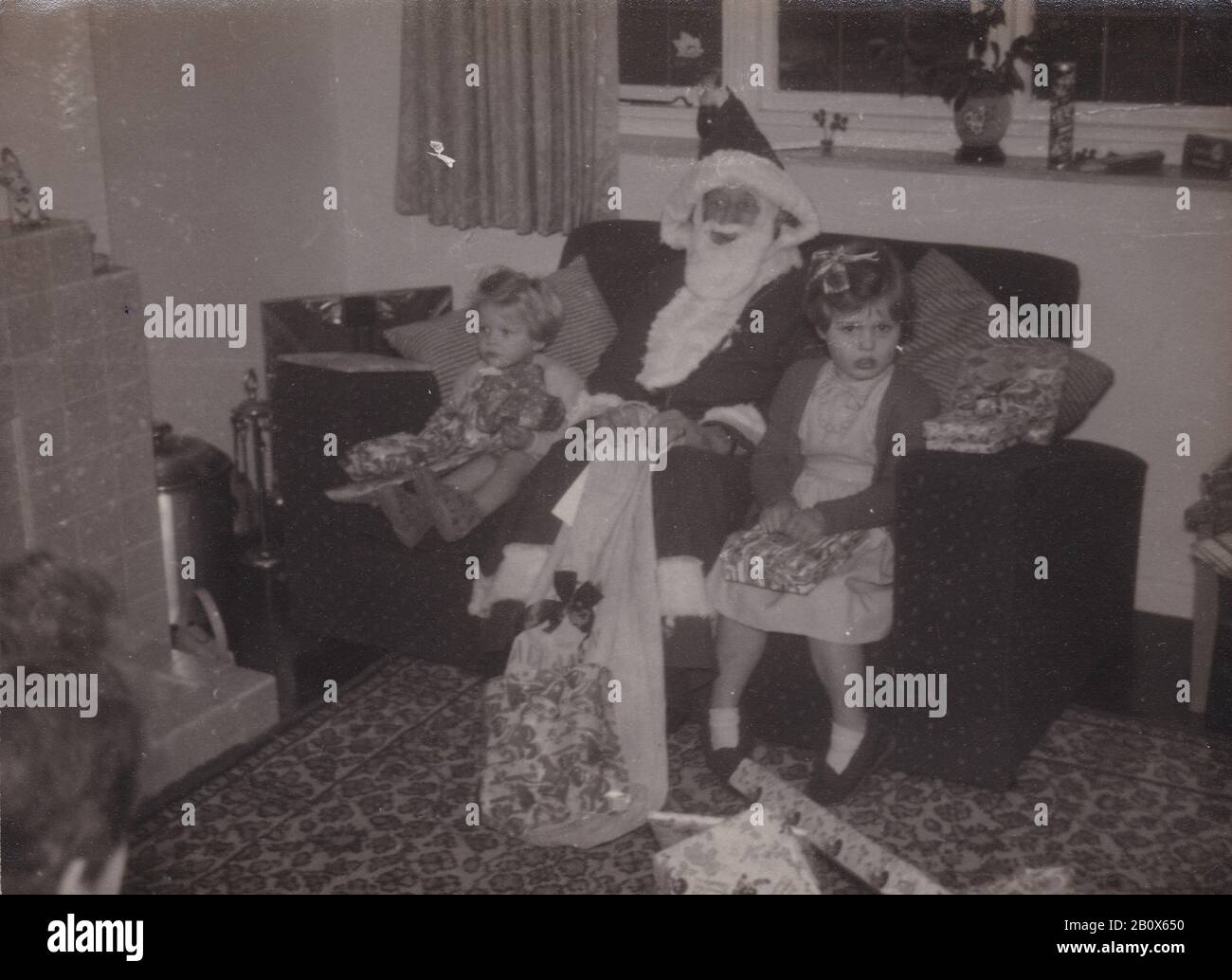 Vintage black and white photo of children at Christmas 1950s Stock Photo