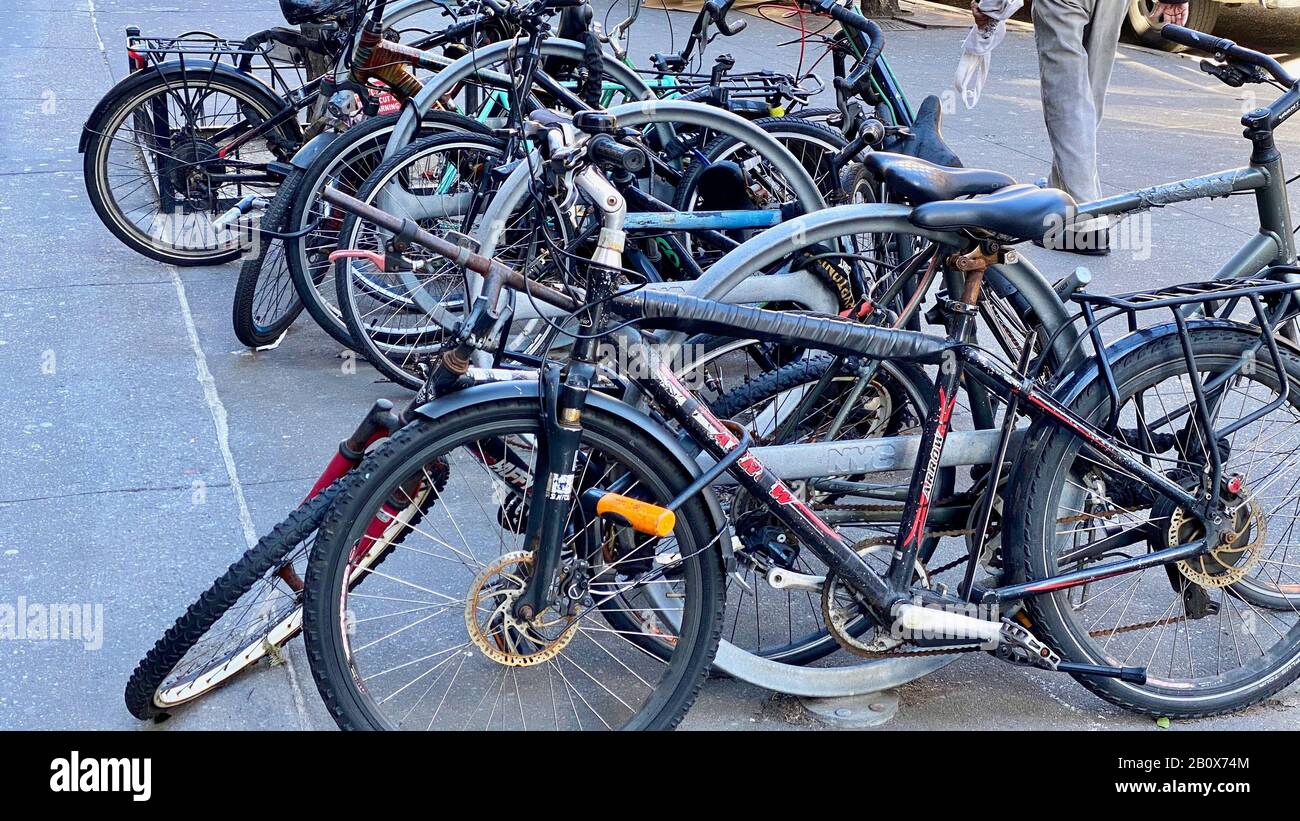 Bicycles crowded to together to enable locking with a shortage of bike racks Stock Photo