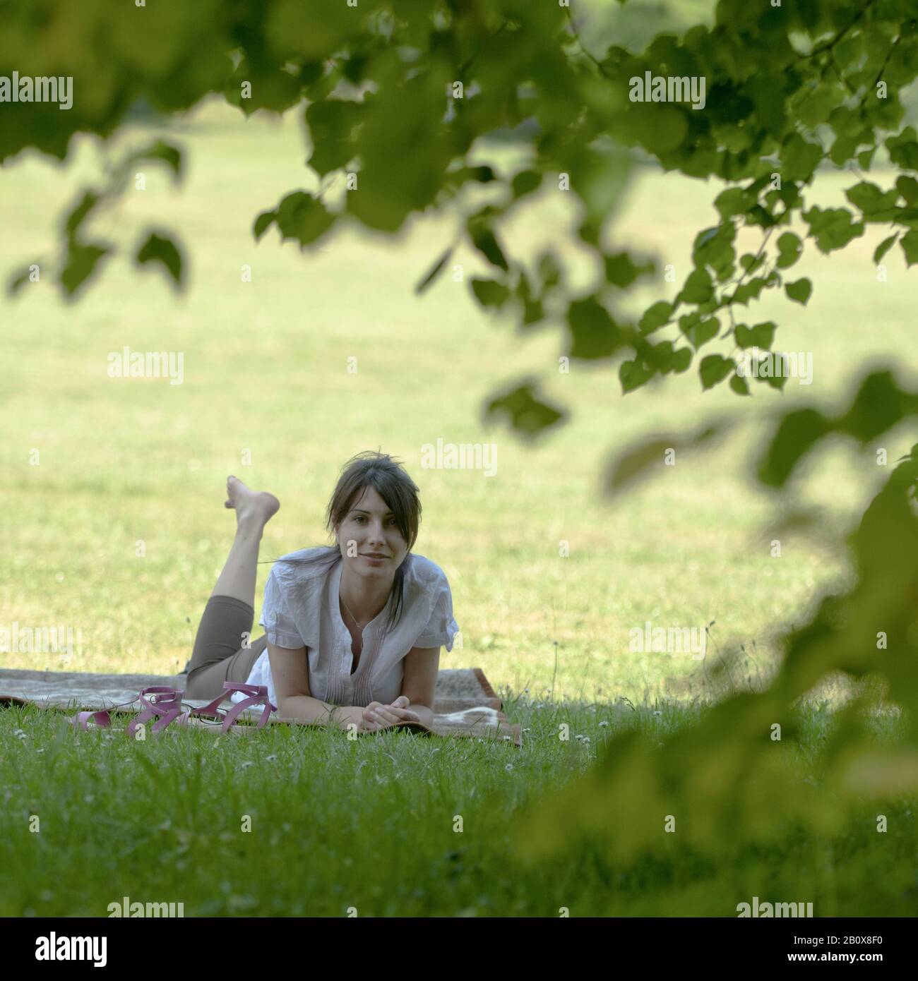 Young woman lying on a meadow Stock Photo