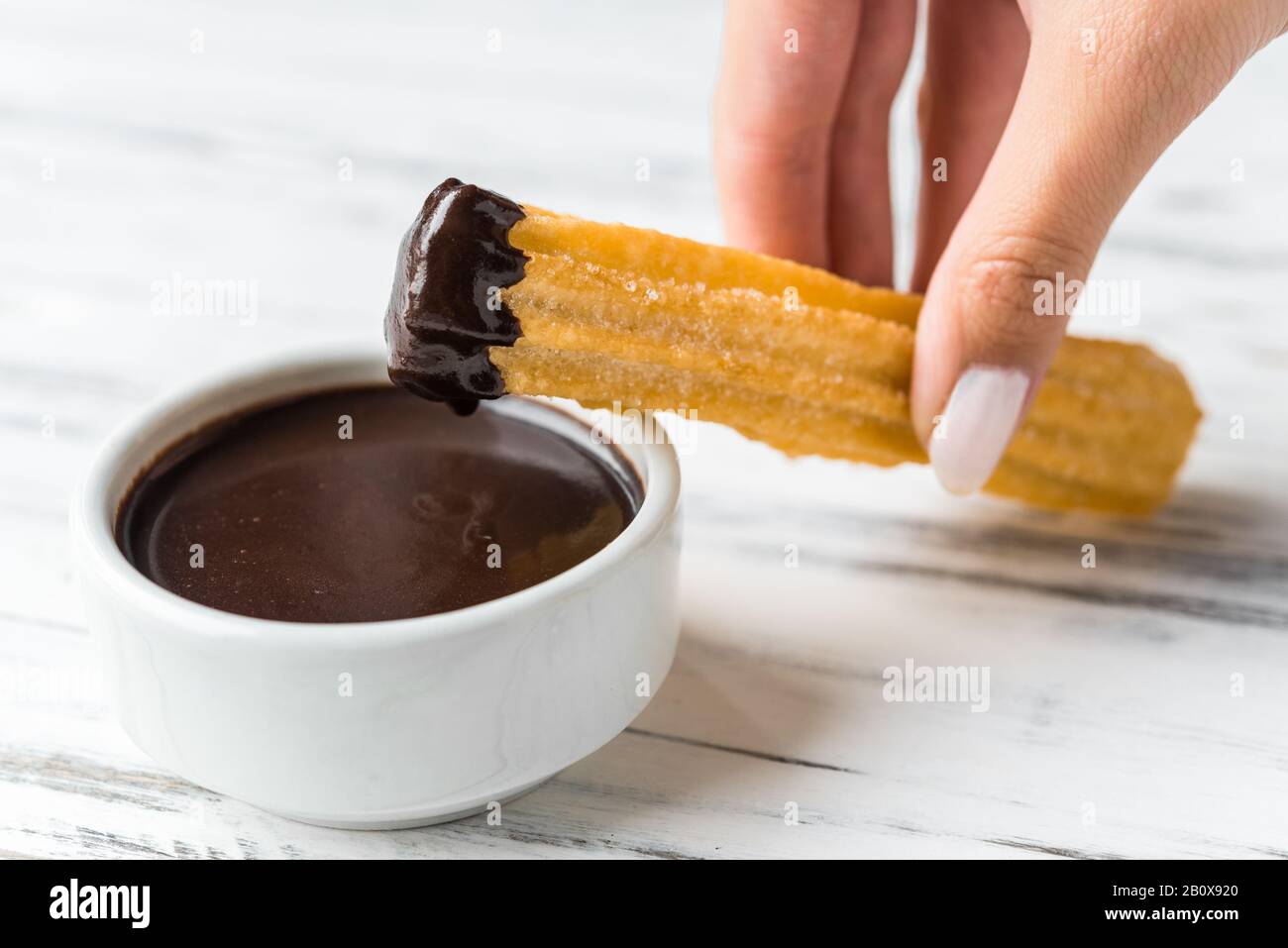 Churros with chocolate, a traditional Spanish sweet food pastry dessert. Stock Photo