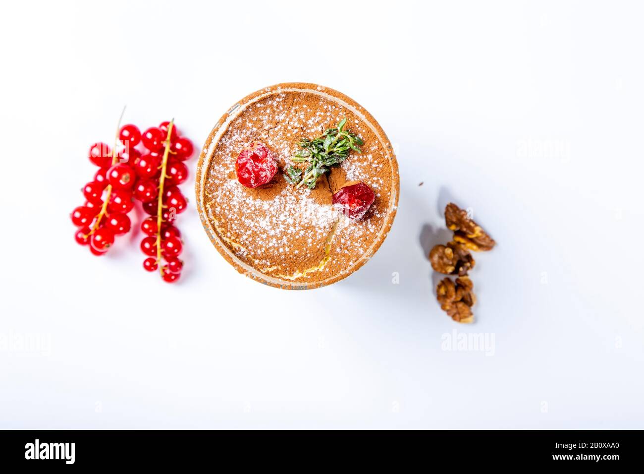 Panna cotta dessert in a clear glass. The dessert is decorated with