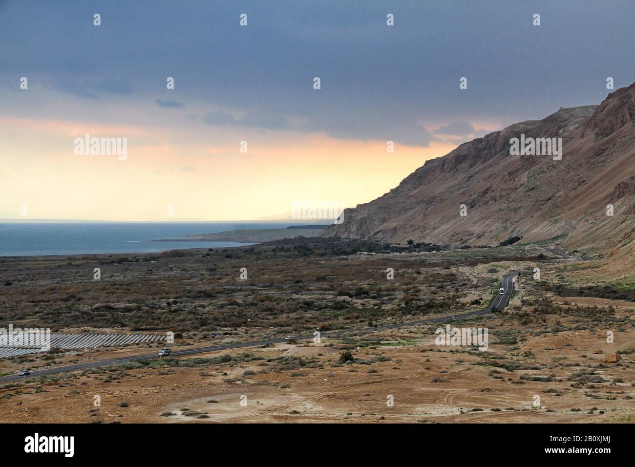 Standing at Qumran National Park offers a panoramic view of the Dead Sea and the surrounding mountains and desert along Highway 90 in Israel. Stock Photo