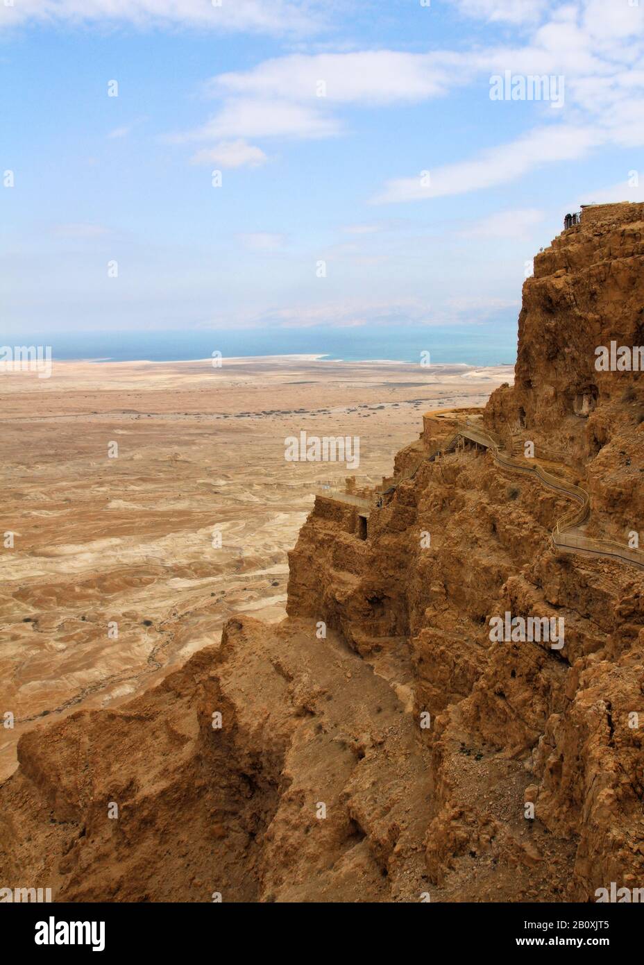 A view of the cliffs and plateau of Masada with the backdrop of the Dead Sea in Israel. Stock Photo