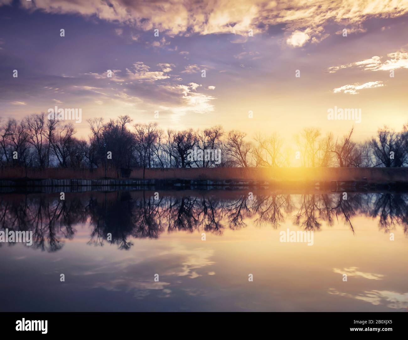 Sunset over the lake, sunset reflection on the water Stock Photo - Alamy