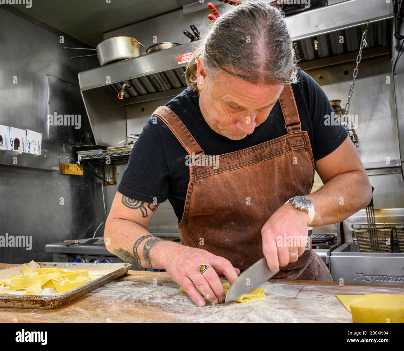 Chef and co-owner Raymond Southern preparing his specialty pasta at Kingfish Inn Restaurant in West Sound on Orcas Island, San Juan Islands, Washingto Stock Photo