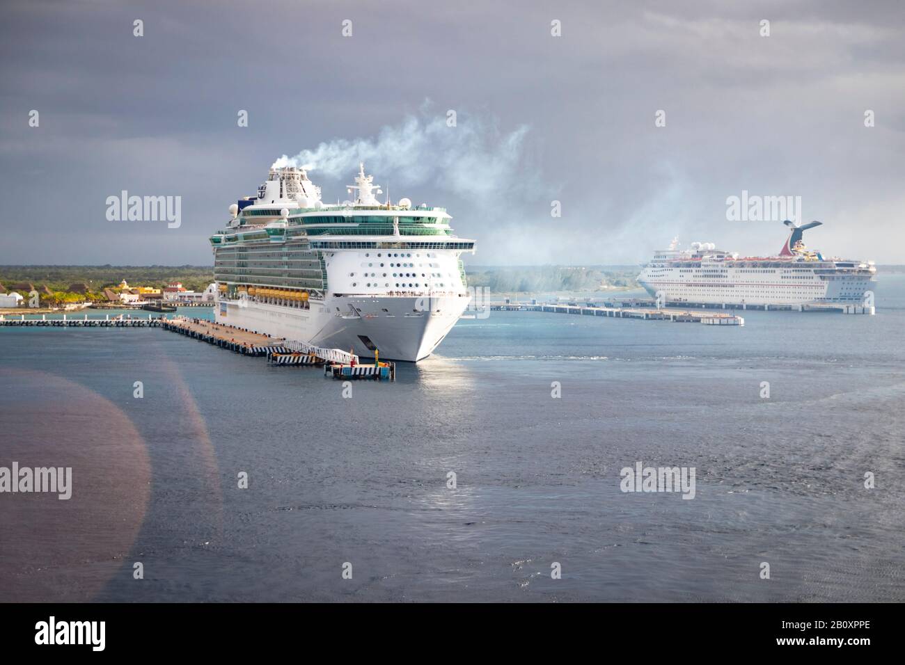 Royal Caribbean cruise ship at port, emitting smoke/steam and preparing to embark Stock Photo