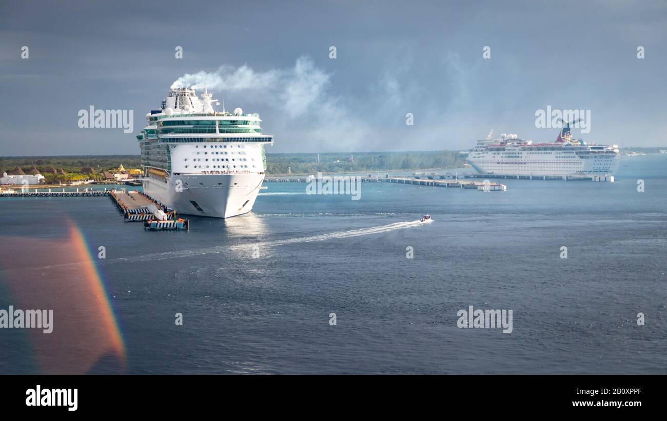 Royal Caribbean cruise ship at port, emitting smoke/steam and preparing to embark Stock Photo