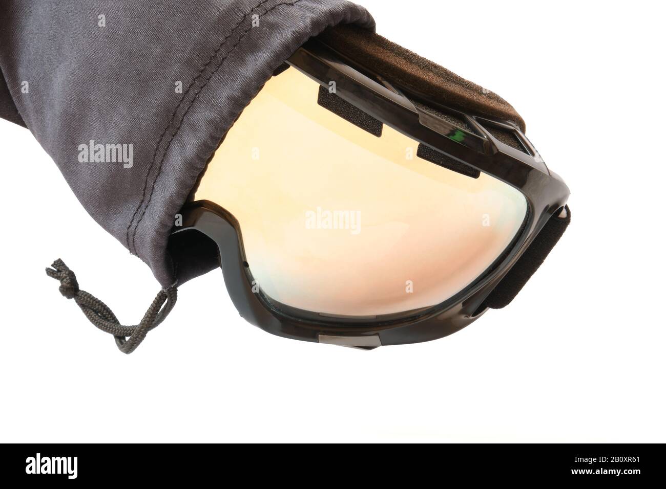 Ski goggles with reflective mirror, partly pulled out from its black textile pouch/cloth bag, isolated on white background. Stock Photo