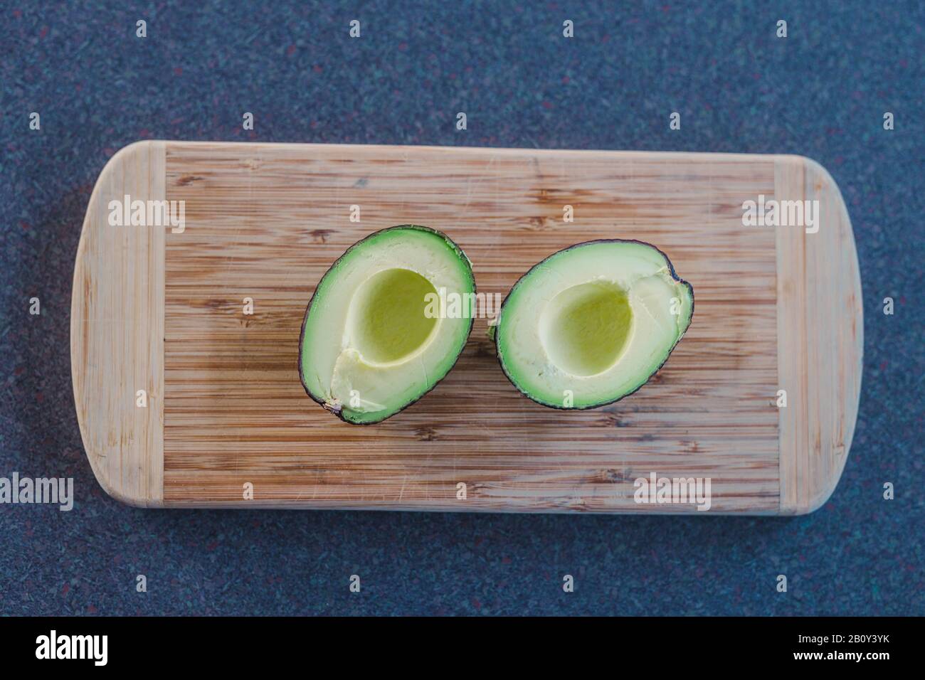 healthy ingredients for a plantbased diet, avocado cut in halves on