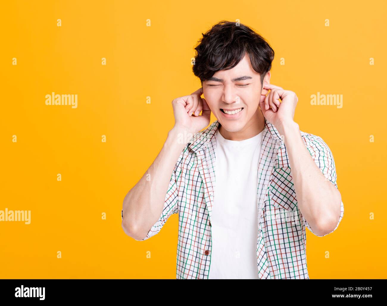 Closeup portrait of  young  man with hand over his ear Stock Photo
